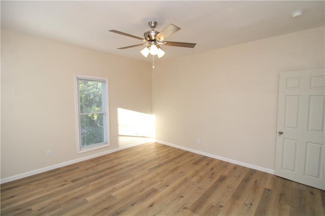 empty room with ceiling fan and wood-type flooring