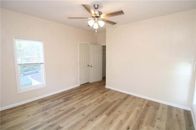 empty room featuring light wood-type flooring and ceiling fan