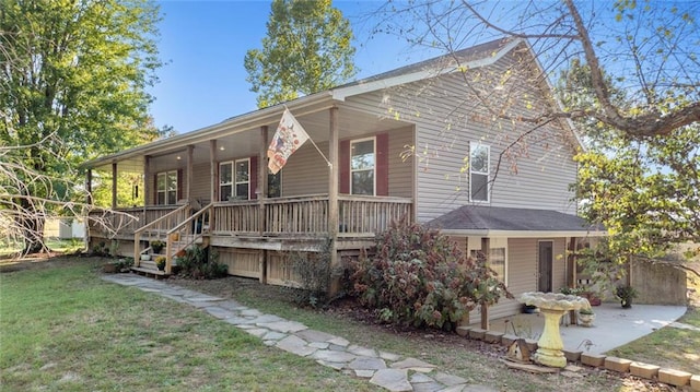 back of property with a porch and a lawn