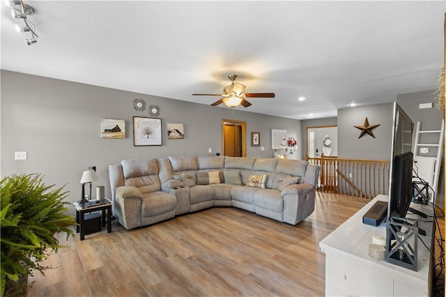 living room with ceiling fan and light hardwood / wood-style floors