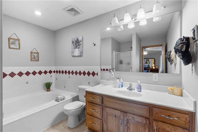 full bathroom featuring ceiling fan, vanity, toilet, shower with separate bathtub, and tile patterned flooring