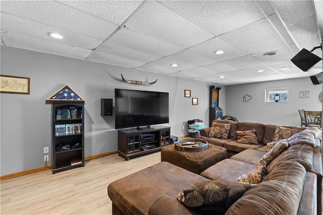 living room with light hardwood / wood-style flooring and a drop ceiling