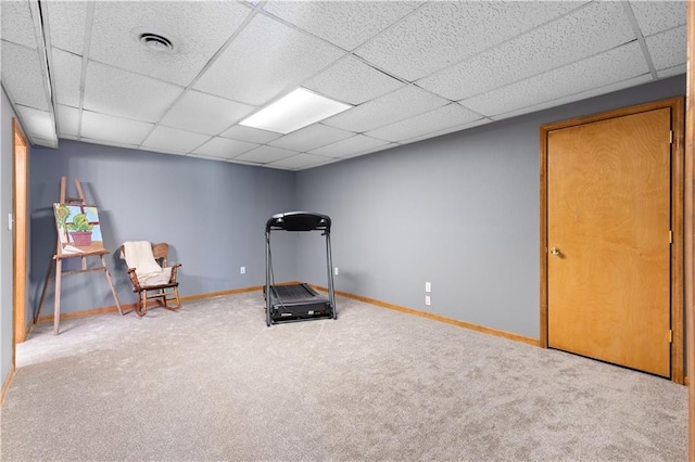 workout area with carpet floors and a paneled ceiling