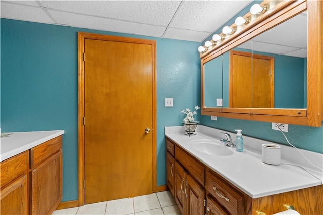 bathroom featuring vanity, a paneled ceiling, and tile patterned flooring