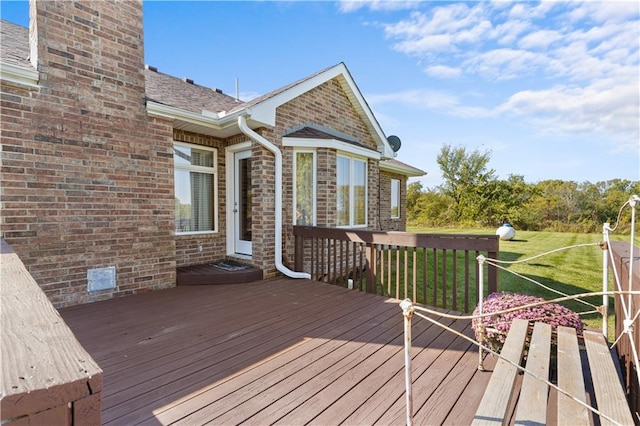 wooden terrace featuring a lawn