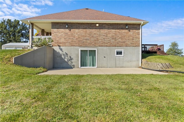 back of property featuring a yard and a patio