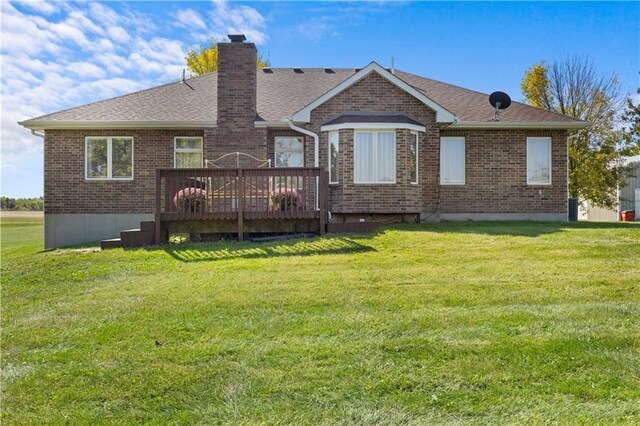 back of house featuring a deck and a yard