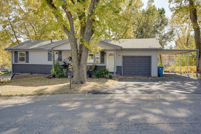 1101 Williams St, Excelsior Springs, MO 64024 - view of front of property featuring driveway, brick siding, an attached garage, and a carport
