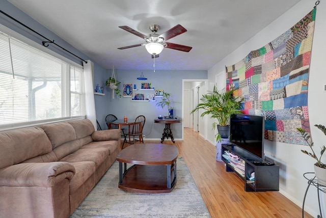 living room featuring ceiling fan and hardwood / wood-style flooring