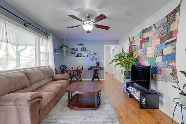 1101 Williams St, Excelsior Springs, MO 64024 - living area featuring ceiling fan, wood finished floors, and baseboards