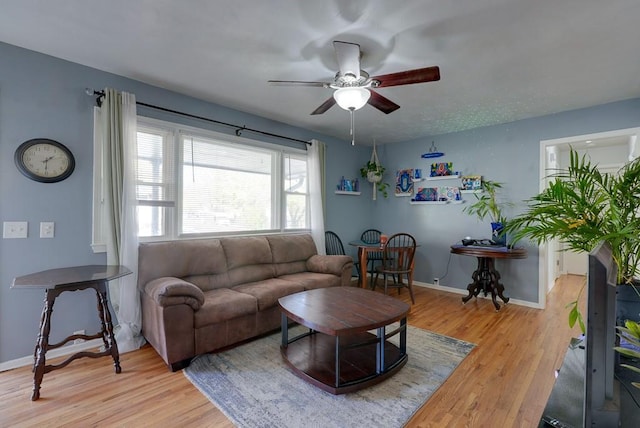 1101 Williams St, Excelsior Springs, MO 64024 - living area featuring a ceiling fan, light wood-style floors, and baseboards