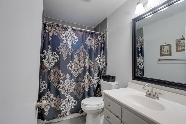 1101 Williams St, Excelsior Springs, MO 64024 - bathroom featuring toilet, tile patterned flooring, vanity, and curtained shower