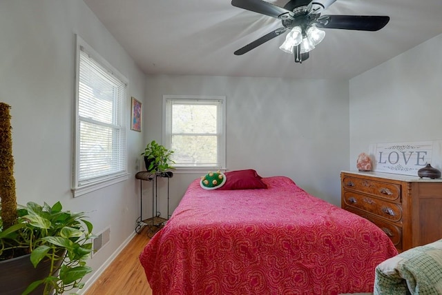 bedroom with light hardwood / wood-style flooring and ceiling fan