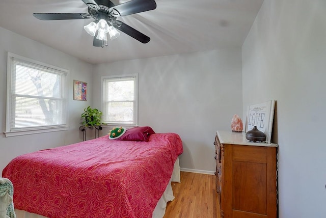 bedroom with light wood-type flooring and ceiling fan