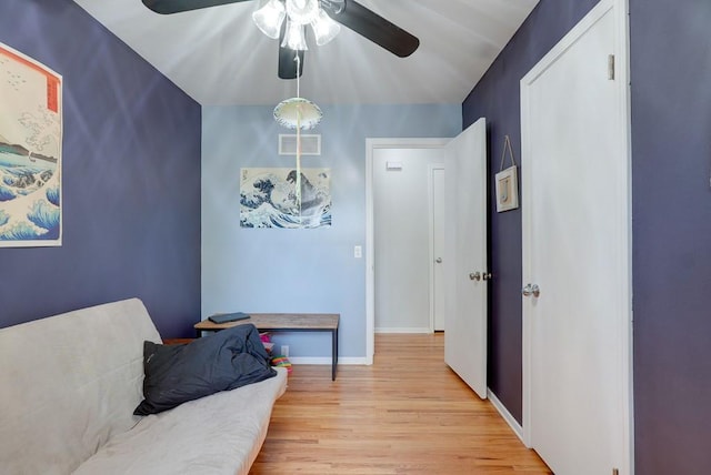 living area with light wood-type flooring and ceiling fan