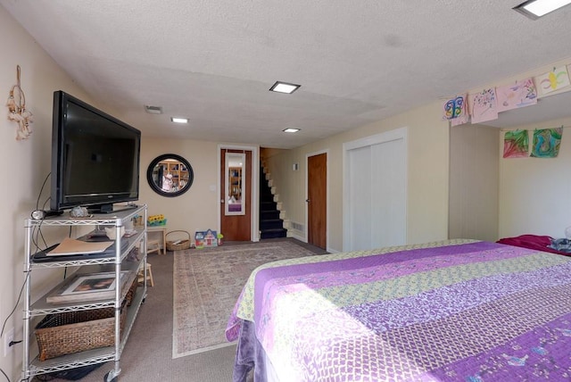 carpeted bedroom with a textured ceiling