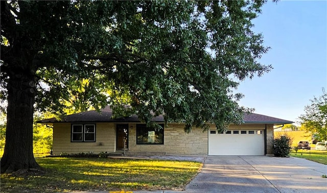 single story home with a garage and a front lawn