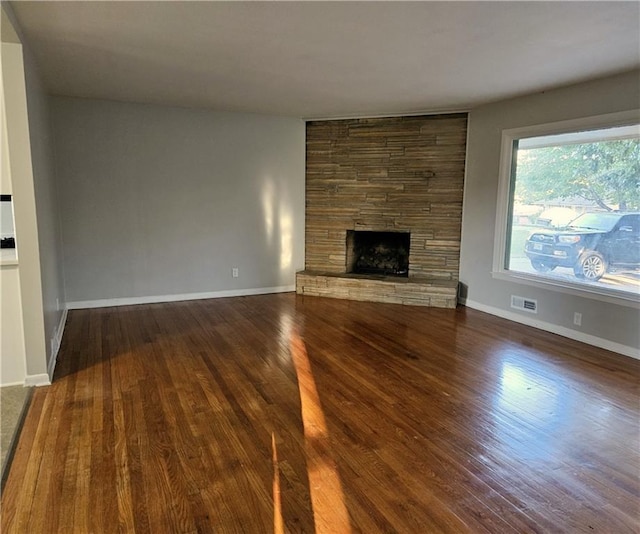 unfurnished living room featuring dark hardwood / wood-style floors and a fireplace