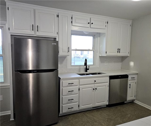 kitchen with tasteful backsplash, white cabinetry, sink, and appliances with stainless steel finishes