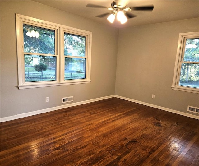 spare room with dark hardwood / wood-style floors and ceiling fan