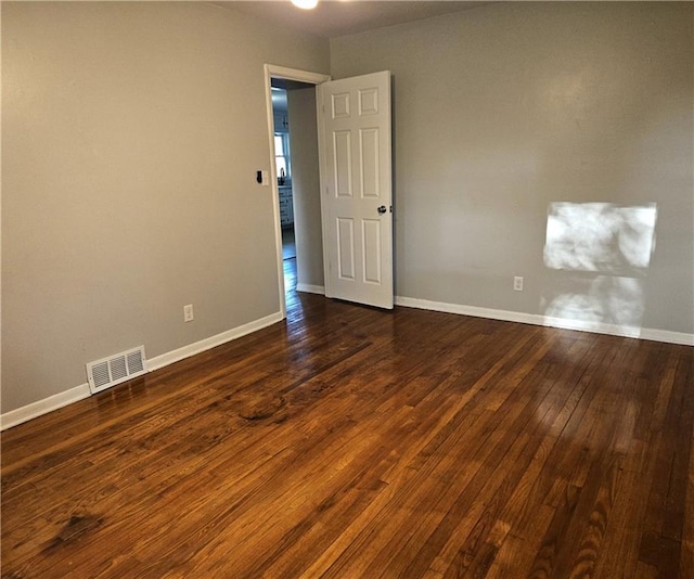 spare room featuring dark hardwood / wood-style flooring