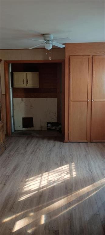 unfurnished living room with light hardwood / wood-style flooring and ceiling fan