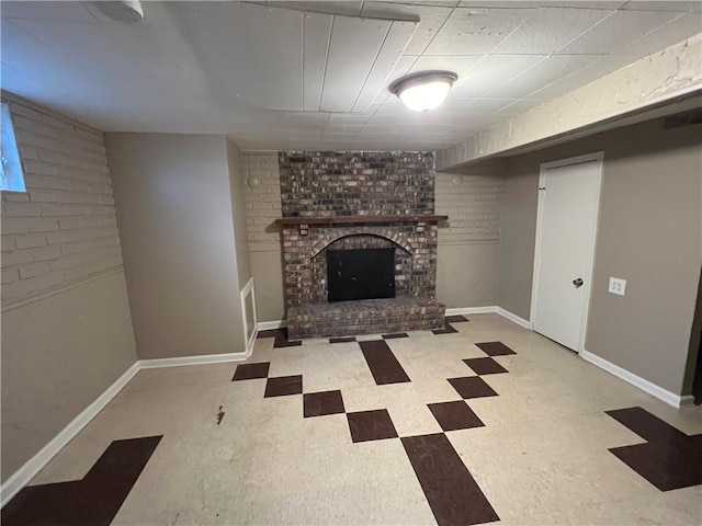 unfurnished living room featuring a brick fireplace