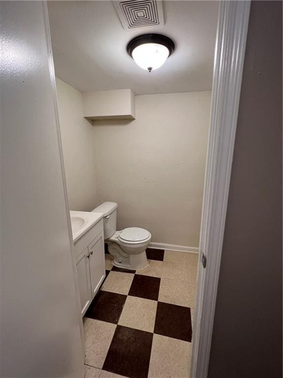 bathroom featuring vanity and toilet