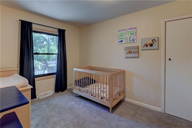 bedroom featuring carpet and a crib