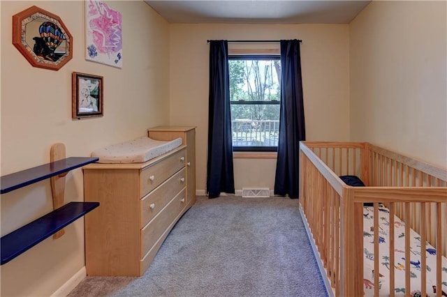 unfurnished bedroom featuring light carpet and a crib