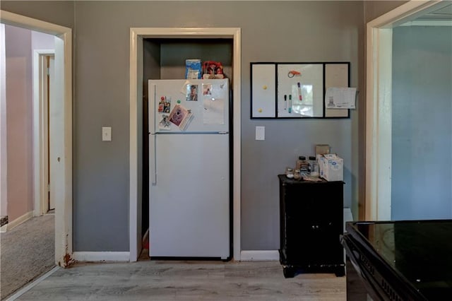 kitchen featuring white fridge and light hardwood / wood-style flooring