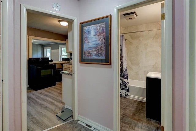 bathroom featuring vanity and shower / bathtub combination with curtain