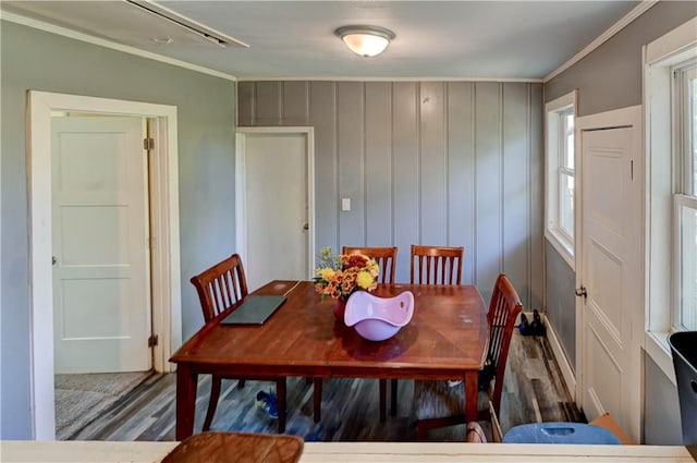 dining area with ornamental molding and hardwood / wood-style floors