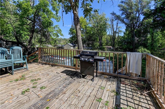 wooden deck featuring area for grilling