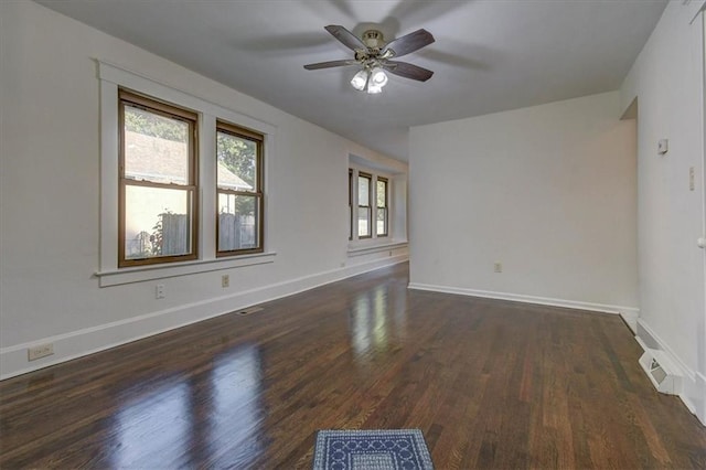 empty room featuring dark hardwood / wood-style flooring and ceiling fan