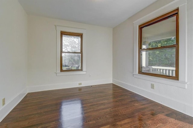 empty room with dark wood-type flooring