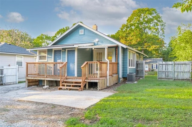 back of house featuring a wooden deck and a yard