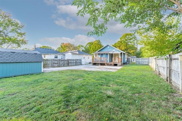 view of yard featuring a wooden deck and a storage unit