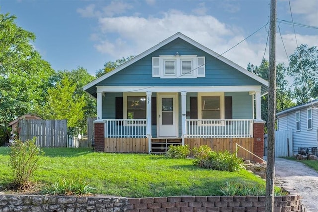 bungalow featuring a front lawn and covered porch