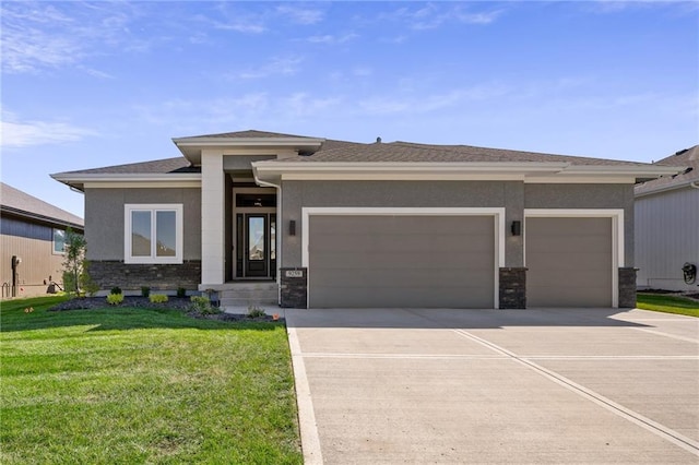 prairie-style home featuring a front yard and a garage