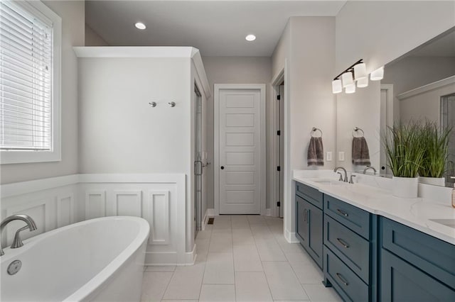 bathroom featuring vanity, a bathtub, plenty of natural light, and tile patterned floors