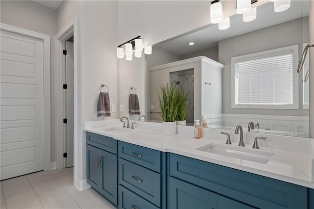 bathroom with tile patterned flooring, vanity, and a bathing tub