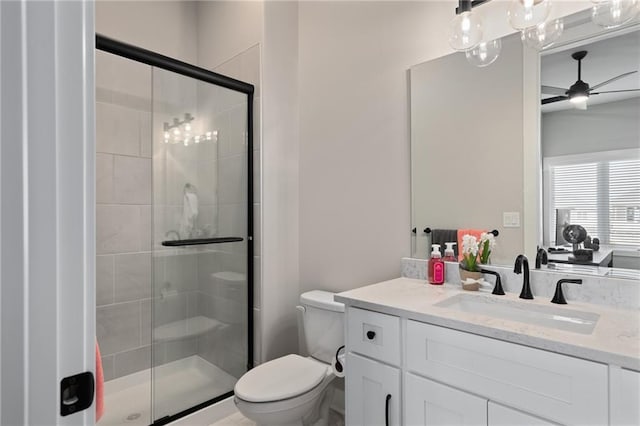 bathroom with walk in shower, ceiling fan with notable chandelier, vanity, and toilet