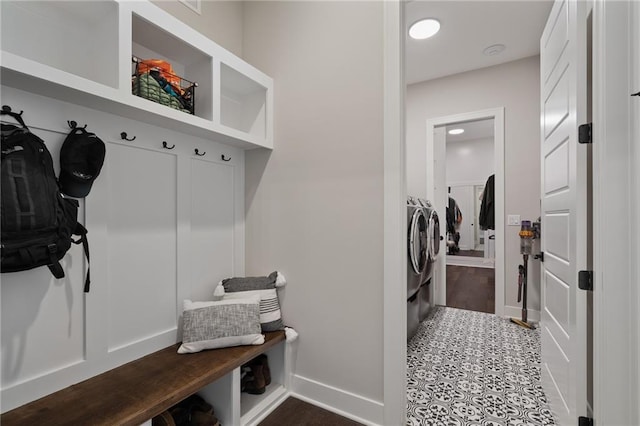 mudroom with washing machine and clothes dryer and dark tile patterned floors