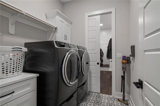 laundry area featuring cabinets, light wood-type flooring, and washer and dryer