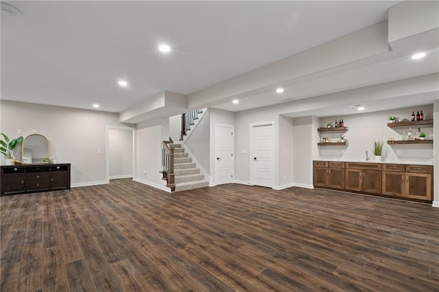 living room with indoor wet bar and dark wood-type flooring