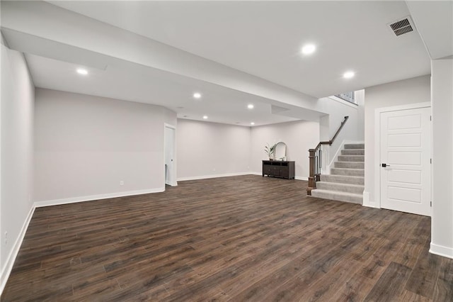 basement featuring dark hardwood / wood-style flooring