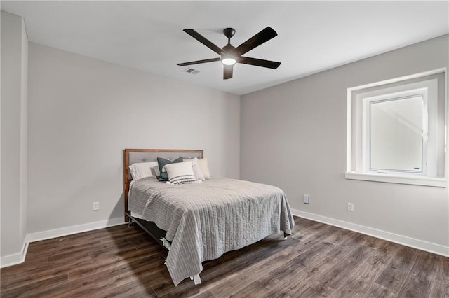 bedroom featuring ceiling fan and dark hardwood / wood-style flooring