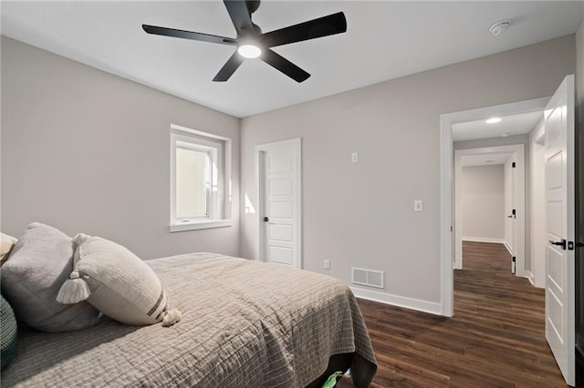 bedroom with ceiling fan and dark hardwood / wood-style flooring