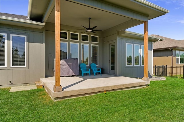 rear view of property with a patio, a yard, and ceiling fan